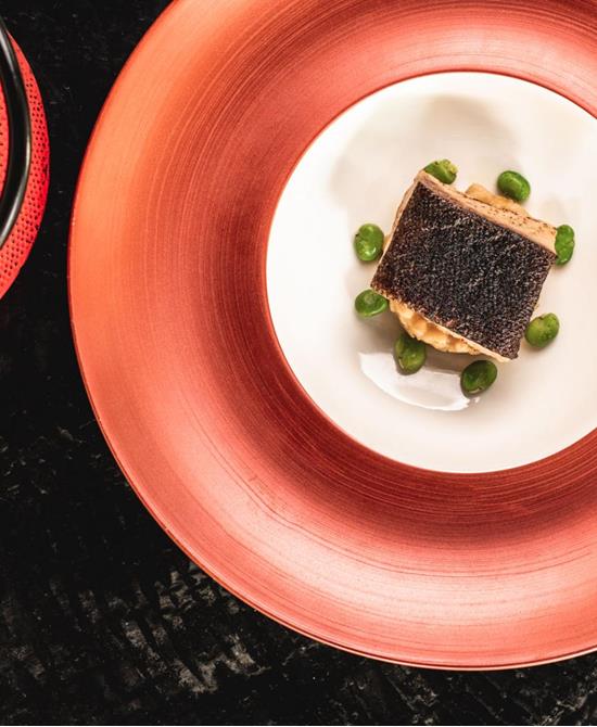 A dish with salmon trout and a tea pot